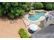 Aerial view of a home showing the backyard pool with a spa, patio, and lush landscaping at 1850 Kirkmont Nw Dr, Marietta, GA 30064