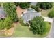 Aerial view of a home showcasing its landscaped front yard and backyard pool oasis at 1850 Kirkmont Nw Dr, Marietta, GA 30064