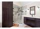 Bathroom showcasing dark cabinetry, a glass shower, and modern fixtures at 1850 Kirkmont Nw Dr, Marietta, GA 30064