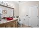Elegant bathroom with stylish vanity, granite countertop, and decorative mirror at 1850 Kirkmont Nw Dr, Marietta, GA 30064