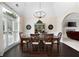 Elegant dining room with vaulted ceiling, chandelier, large windows, and hardwood floors, perfect for entertaining at 1850 Kirkmont Nw Dr, Marietta, GA 30064