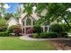 Charming two-story home with stone accents, manicured lawn, and lush landscaping, offering great curb appeal at 1850 Kirkmont Nw Dr, Marietta, GA 30064
