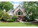 Well-manicured front yard showcasing a home with stone accents and mature trees at 1850 Kirkmont Nw Dr, Marietta, GA 30064