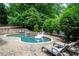 Backyard pool area with a spa, lounge chairs and lush landscaping at 1850 Kirkmont Nw Dr, Marietta, GA 30064