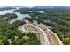 Aerial view of a lakeside community showcasing homes nestled among lush trees, offering scenic waterfront living at 1969 Lanier Harbor Pt, Buford, GA 30518