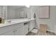 Bathroom featuring a double sink, white cabinets, wood-look floors, modern lighting, and a decorative framed print at 1969 Lanier Harbor Pt, Buford, GA 30518