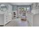 Charming Bedroom featuring soft blue walls, white furniture, and a cozy reading nook at 1969 Lanier Harbor Pt, Buford, GA 30518