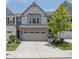 Charming townhouse with a two-car garage, neat landscaping, and an inviting facade at 1969 Lanier Harbor Pt, Buford, GA 30518