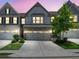 Charming townhouse with a two-car garage, neat landscaping, and an inviting facade at 1969 Lanier Harbor Pt, Buford, GA 30518