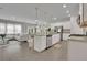 Open-concept kitchen features an island with granite countertops and stainless steel appliances at 1969 Lanier Harbor Pt, Buford, GA 30518