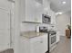 Modern kitchen featuring white cabinets, stainless steel appliances, and granite countertops at 1969 Lanier Harbor Pt, Buford, GA 30518
