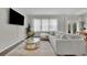 Comfortable living room with a large sectional sofa, modern decor, and plenty of natural light at 1969 Lanier Harbor Pt, Buford, GA 30518