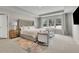 Luxurious main bedroom with a tray ceiling, seating area, and an abundance of natural light at 1969 Lanier Harbor Pt, Buford, GA 30518