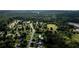 Property aerial view highlighting the backyard swimming pool and lush surroundings of the neighborhood at 7090 Valley Landing Ct, Cumming, GA 30041