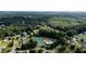 Scenic aerial view of community amenities including tennis courts and a sparkling swimming pool at 7090 Valley Landing Ct, Cumming, GA 30041