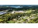 Aerial view of a residential neighborhood with mature trees, a school, and a glimpse of the nearby lake at 7090 Valley Landing Ct, Cumming, GA 30041