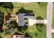 Aerial view of the property showcasing the house, driveway, and landscaped backyard with a patio at 7090 Valley Landing Ct, Cumming, GA 30041