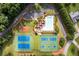 Overhead view of community amenities with tennis courts, swimming pool, and playground at 7090 Valley Landing Ct, Cumming, GA 30041