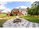 Large backyard featuring a fire pit, patio area, and lush green lawn, perfect for outdoor entertaining at 7090 Valley Landing Ct, Cumming, GA 30041