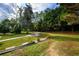 Spacious backyard with a fire pit and well-maintained lawn, perfect for outdoor gatherings and relaxation at 7090 Valley Landing Ct, Cumming, GA 30041