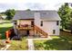 Spacious backyard with a wooden deck, stone walkway, and mature trees providing shade and privacy at 7090 Valley Landing Ct, Cumming, GA 30041