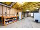 Unfinished basement with exposed insulation, work bench, and concrete flooring at 7090 Valley Landing Ct, Cumming, GA 30041