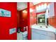 Bright red bathroom with a vanity and open view of the basement at 7090 Valley Landing Ct, Cumming, GA 30041