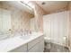 Bathroom with floral wallpaper, shower with curtain, and modern fixtures at 7090 Valley Landing Ct, Cumming, GA 30041