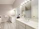 Bright bathroom with double sinks, white cabinetry, and updated fixtures for a modern look at 7090 Valley Landing Ct, Cumming, GA 30041