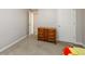 Bedroom with plush carpet, a wooden dresser, and neutral paint at 7090 Valley Landing Ct, Cumming, GA 30041