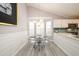 Eat-in kitchen area featuring a modern glass dining table and lots of natural light at 7090 Valley Landing Ct, Cumming, GA 30041