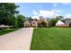 Beautiful brick home with a meticulously landscaped yard, long driveway, and mature trees at 7090 Valley Landing Ct, Cumming, GA 30041
