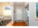 Welcoming foyer featuring hardwood floors, a white front door, and access to adjacent rooms at 7090 Valley Landing Ct, Cumming, GA 30041