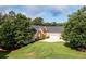 Attractive home with a two-car garage, lush lawn, and mature trees enhancing the curb appeal at 7090 Valley Landing Ct, Cumming, GA 30041