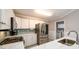 Well-lit kitchen boasts stainless steel appliances, white cabinetry, and a modern design at 7090 Valley Landing Ct, Cumming, GA 30041