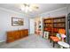 Cozy home office featuring neutral walls, carpeted floor, and abundant storage with wood shelving at 7090 Valley Landing Ct, Cumming, GA 30041