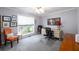 Comfortable home office with large window, neutral carpet, and a ceiling fan for a bright workspace at 7090 Valley Landing Ct, Cumming, GA 30041
