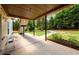 Covered patio area with concrete flooring, offering a shady spot to enjoy the backyard views and peaceful surroundings at 7090 Valley Landing Ct, Cumming, GA 30041
