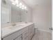 Bright, modern bathroom with dual sinks and vanities, and large mirror at 146 Himalaya Way, Mcdonough, GA 30253