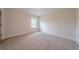 Neutral bedroom with a bright window and plush carpeting at 146 Himalaya Way, Mcdonough, GA 30253