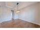 Modern dining room featuring a contemporary lighting fixture and hardwood flooring at 146 Himalaya Way, Mcdonough, GA 30253