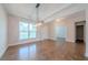 Elegant dining room with modern lighting fixture and hardwood floors at 146 Himalaya Way, Mcdonough, GA 30253