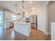 Modern kitchen featuring stainless steel appliances, white cabinets, and a center island at 146 Himalaya Way, Mcdonough, GA 30253