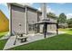 A gray two-story home featuring a backyard patio and an outdoor gazebo, perfect for relaxing and entertaining at 2379 Fallbrook Ct, Duluth, GA 30096