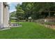 Beautiful backyard with lush green grass, mature trees, and gazebo seating area at 2379 Fallbrook Ct, Duluth, GA 30096