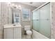 The bathroom includes a shower, toilet, vanity, and a window for natural light at 2379 Fallbrook Ct, Duluth, GA 30096