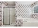 Bathroom featuring a shower, tub, window, and patterned wallpaper at 2379 Fallbrook Ct, Duluth, GA 30096
