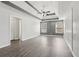Spacious bedroom featuring a tray ceiling, ceiling fan, hardwood floors and abundant natural light at 2379 Fallbrook Ct, Duluth, GA 30096