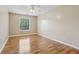 Bedroom showcases a bright window, light-colored walls, and beautiful wood-look laminate flooring at 2379 Fallbrook Ct, Duluth, GA 30096