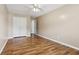 This bedroom includes a ceiling fan, light-colored walls, wood-look laminate flooring, and closet at 2379 Fallbrook Ct, Duluth, GA 30096